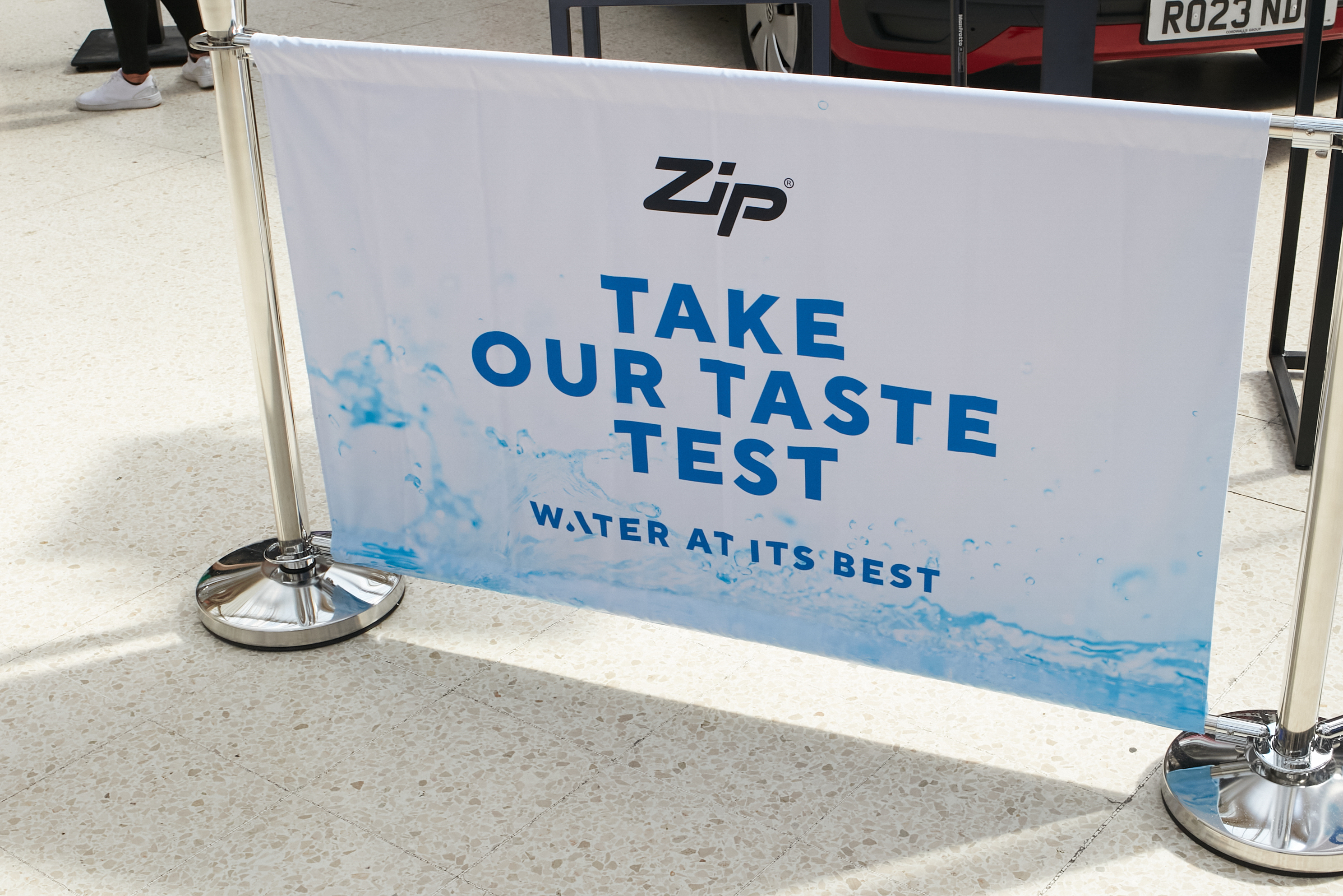 A sign reading 'take our taste test' from Zip Water