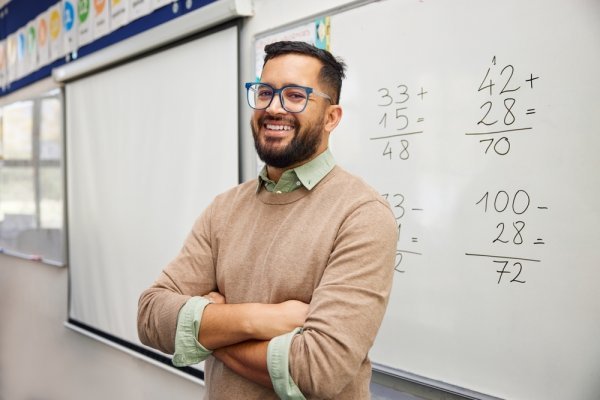 A male teacher in front of a whiteboard