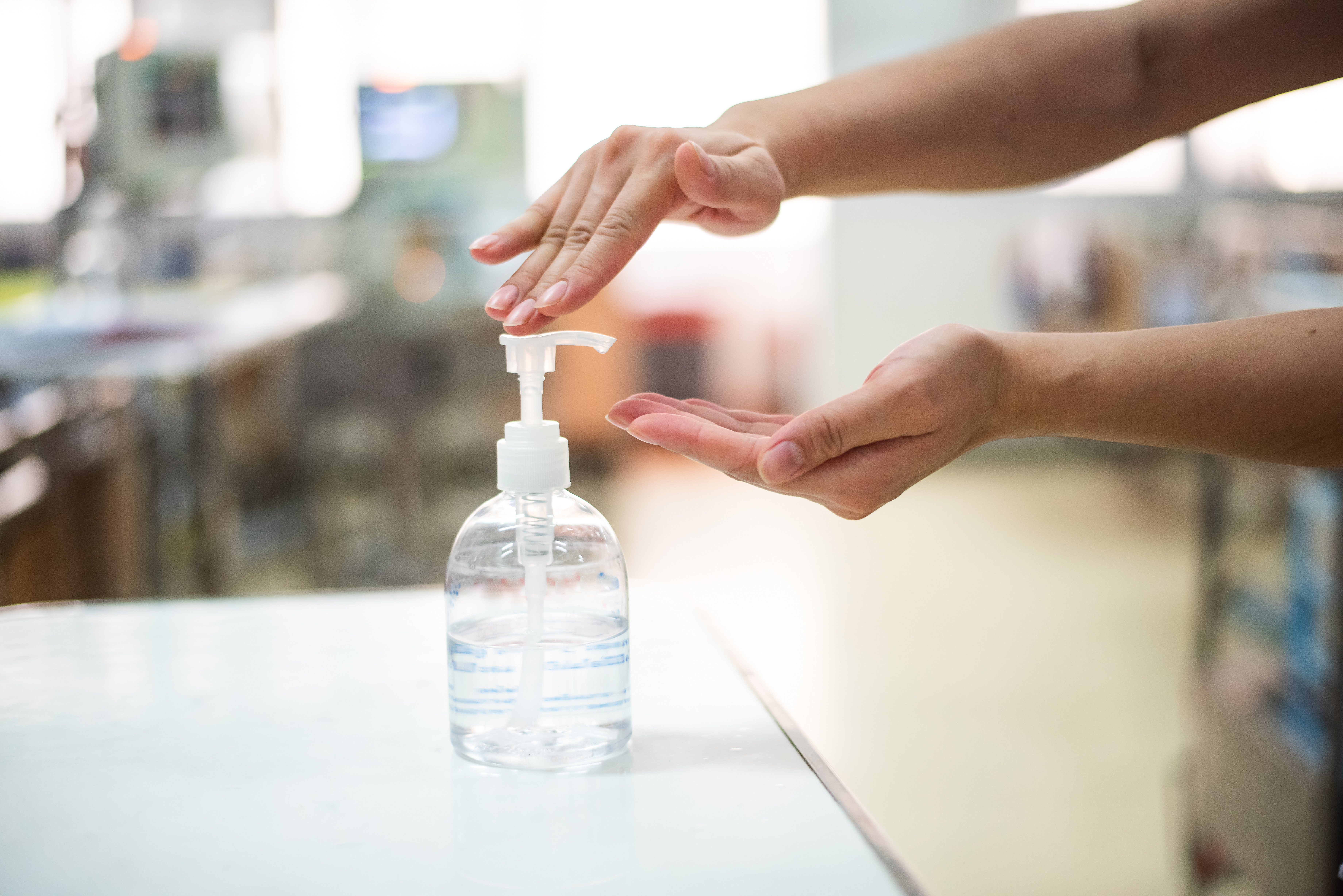 Sanitising hands with hand sanitiser