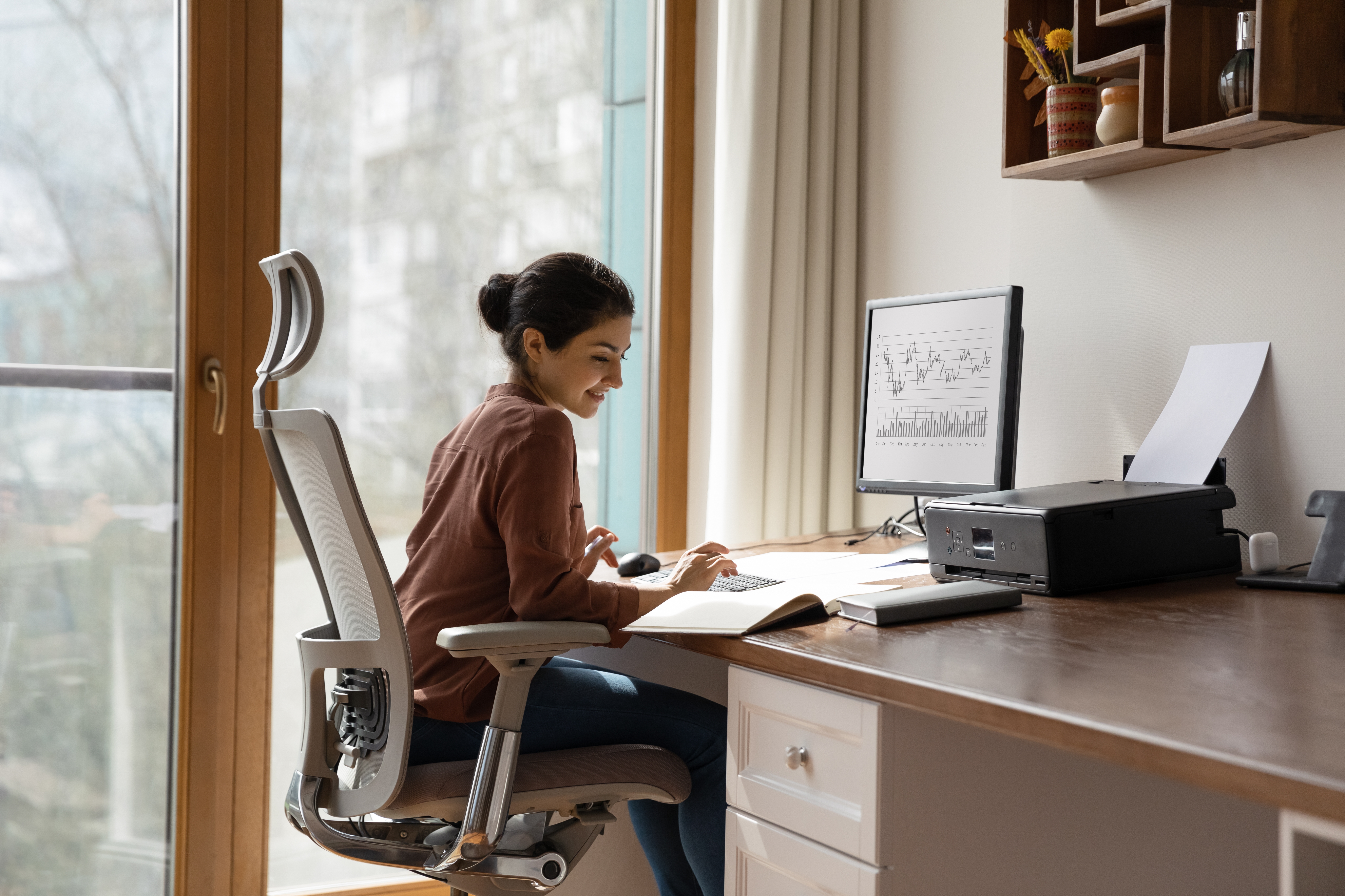 A woman working in a light, airy home office