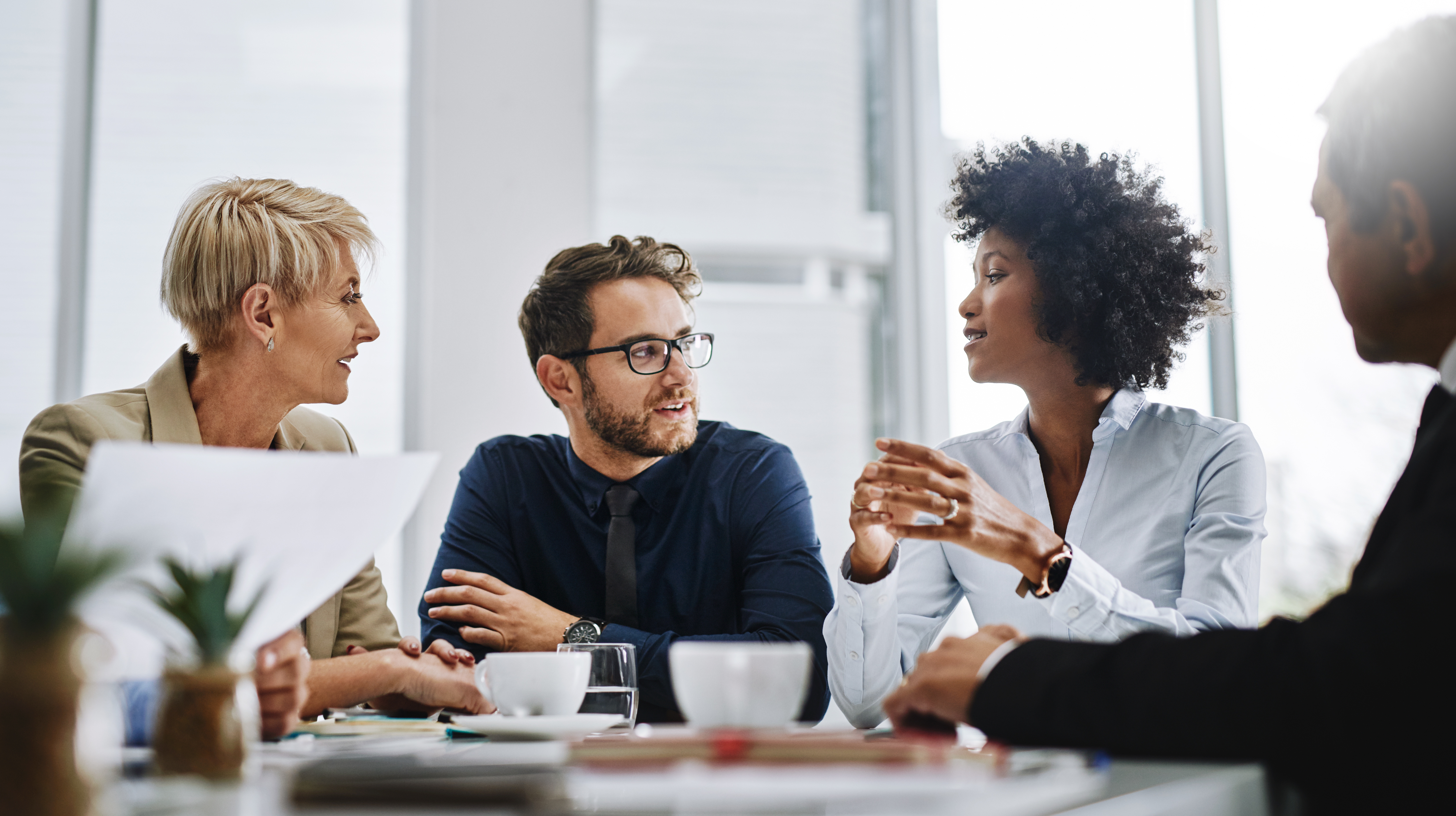 Colleagues connecting in person over coffees