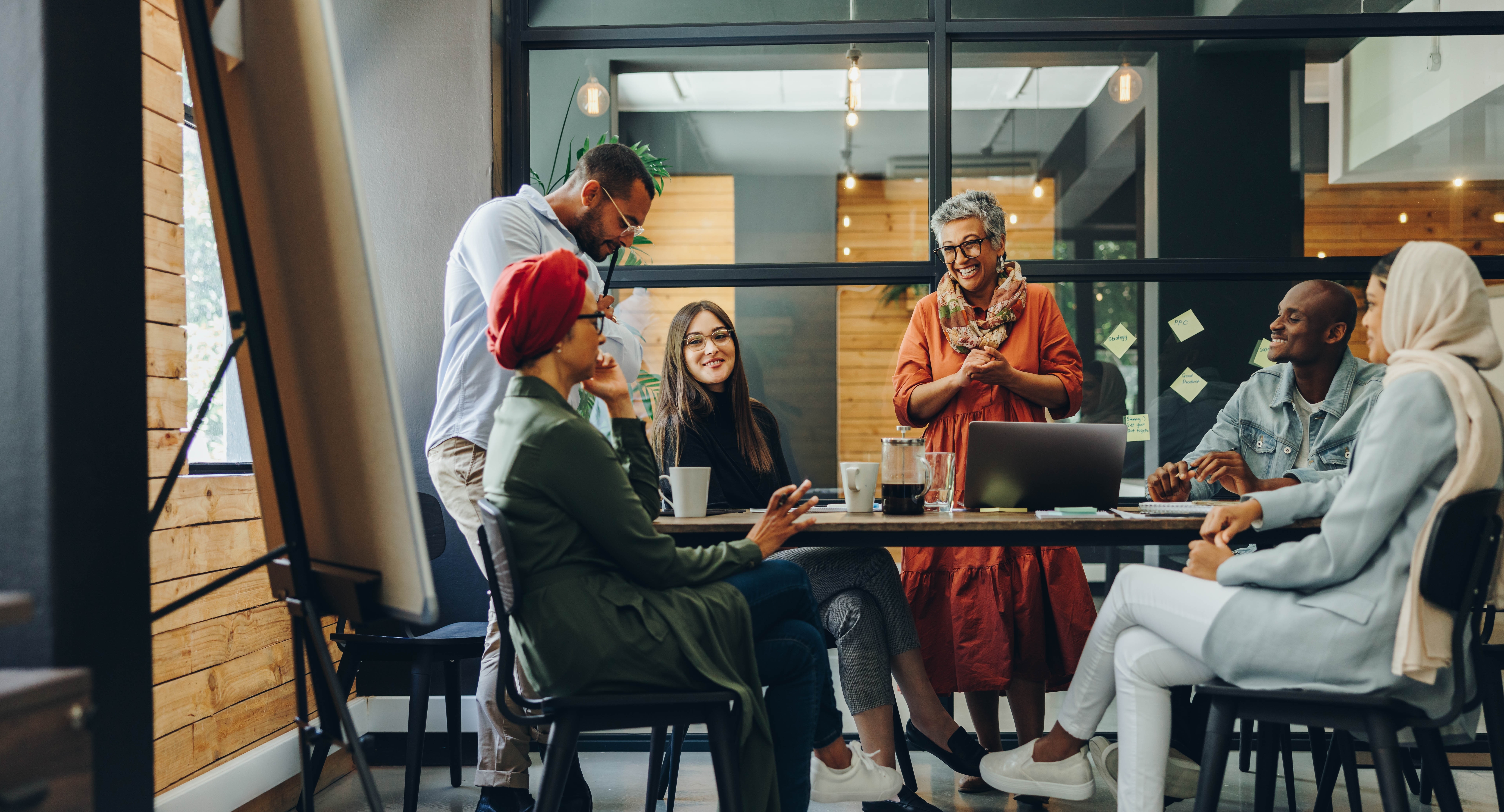 Colleagues conversing in an open breakout space