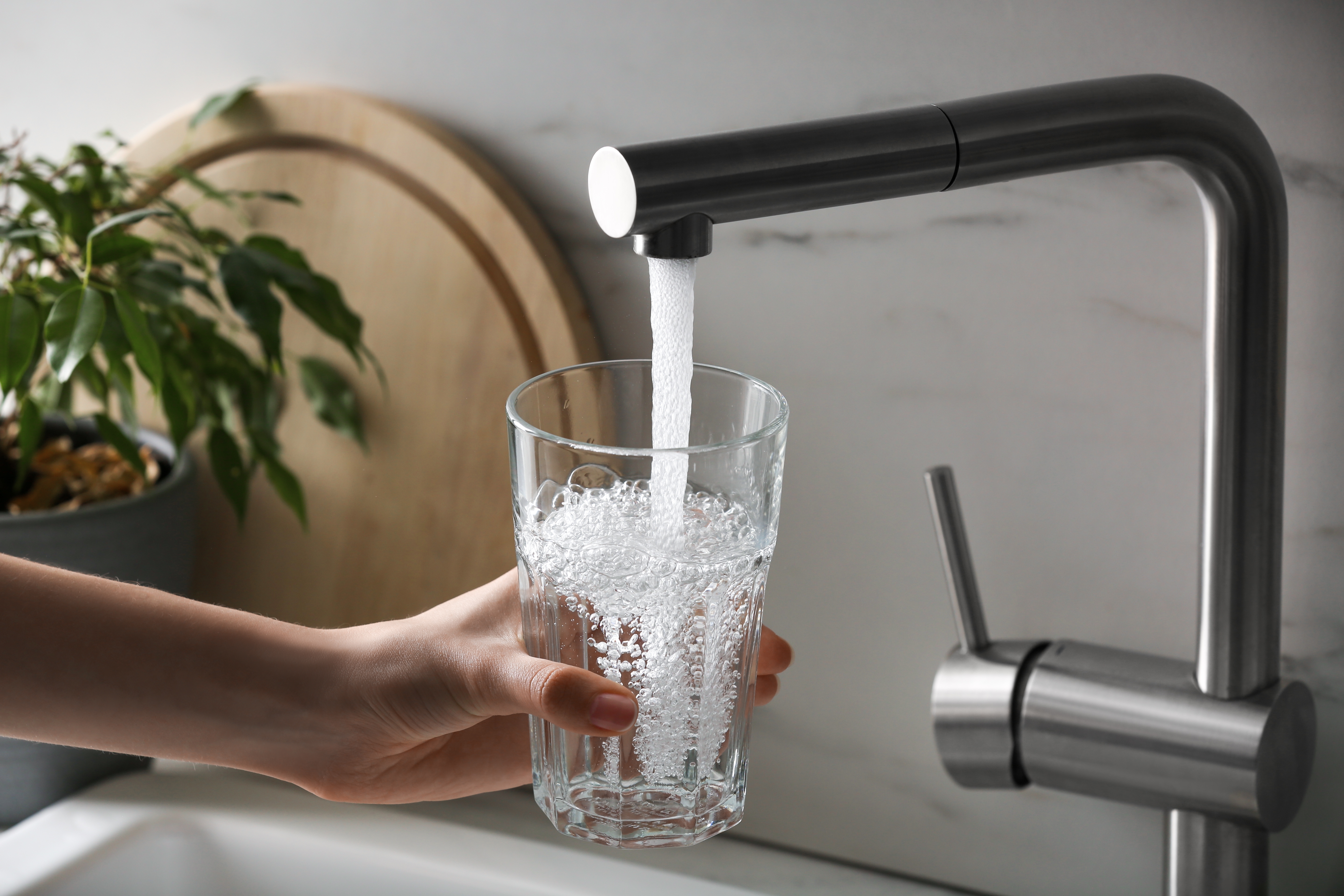 Filling a glass with water from a kitchen tap