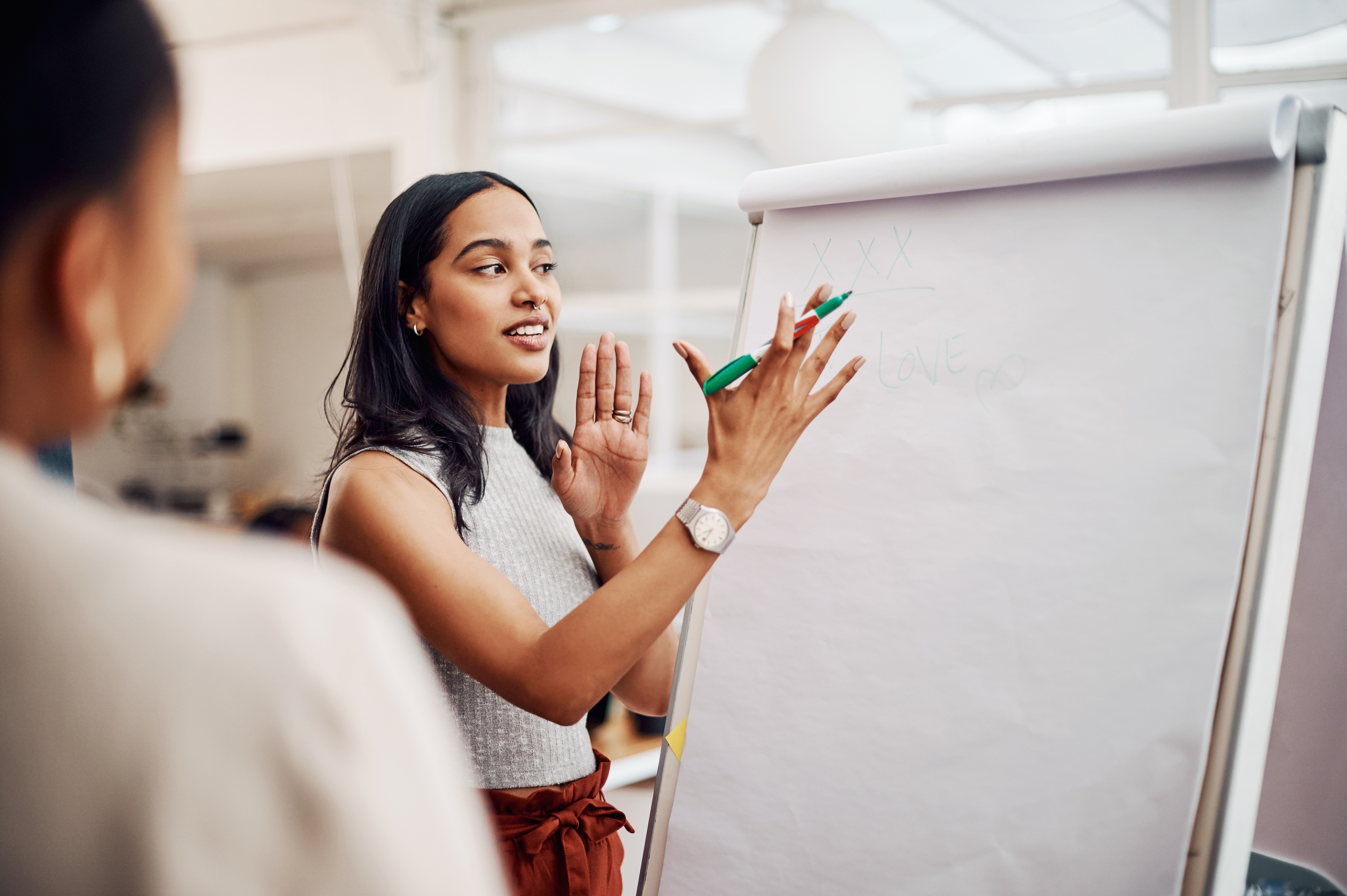 A woman explaining something to her colleague