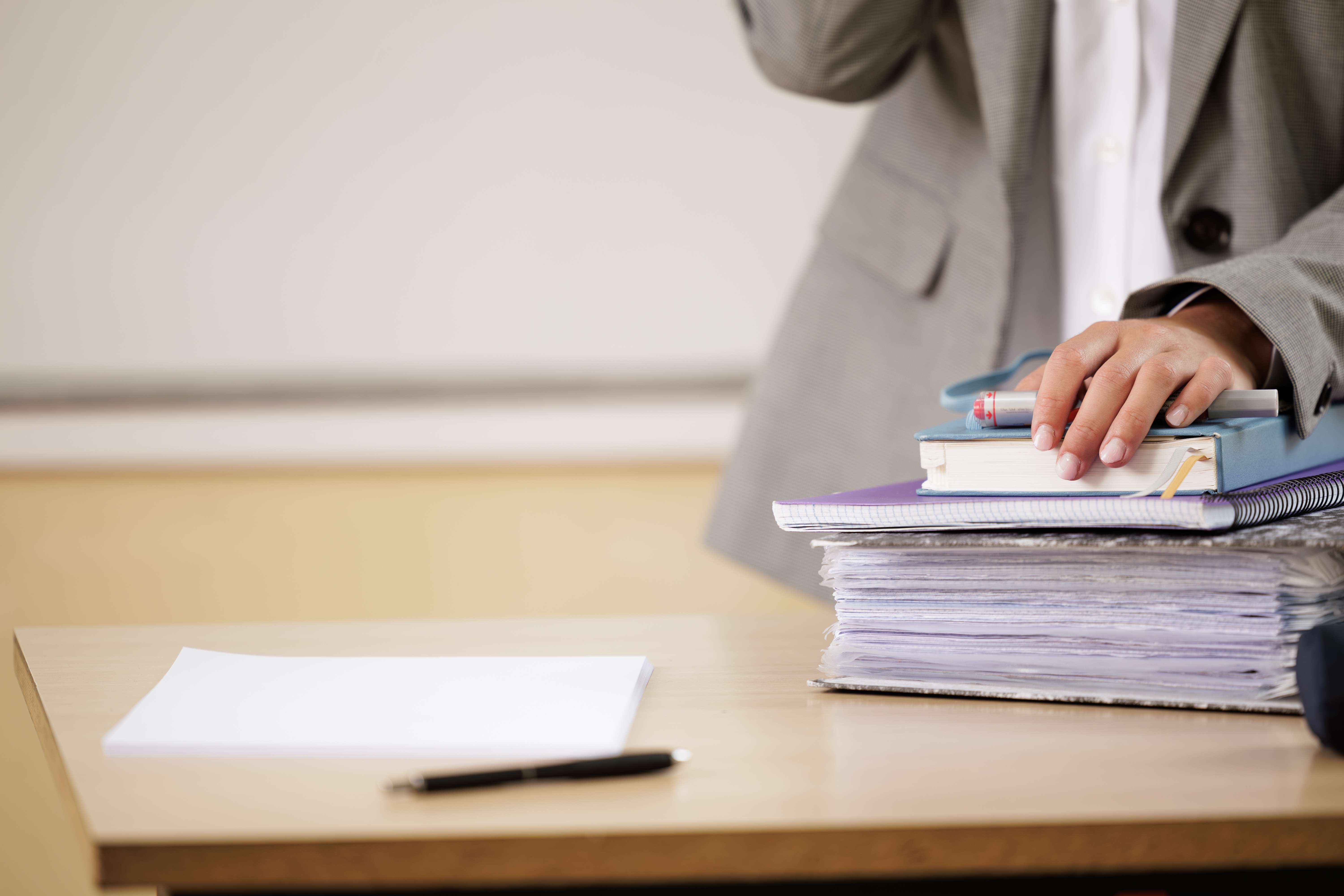 A large pile of work papers on a desk.